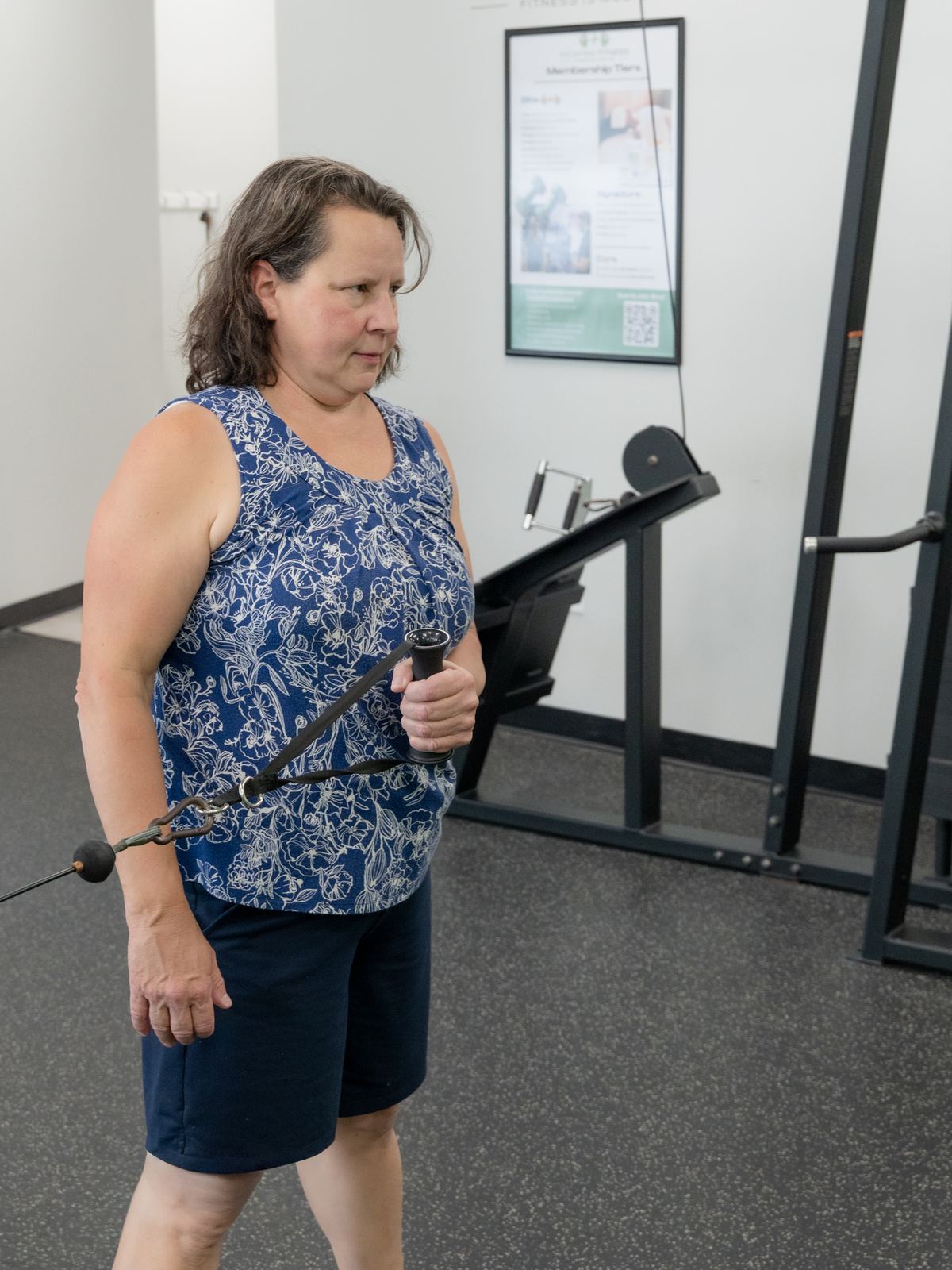 Client guided through a cable exercise during a training session at Redefine Fitness