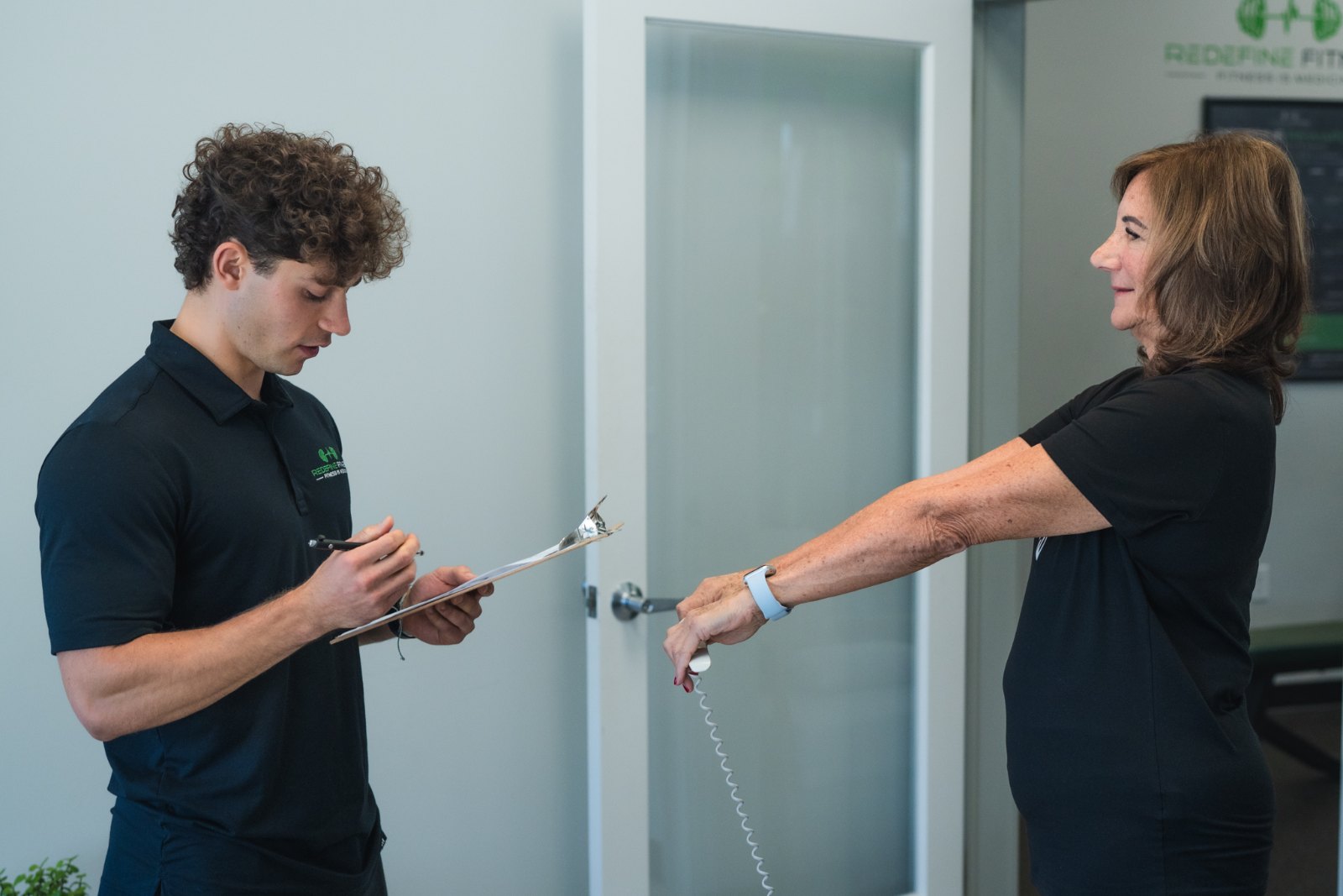 Fitness Specialist recording a client’s InBody scan at Redefine Fitness