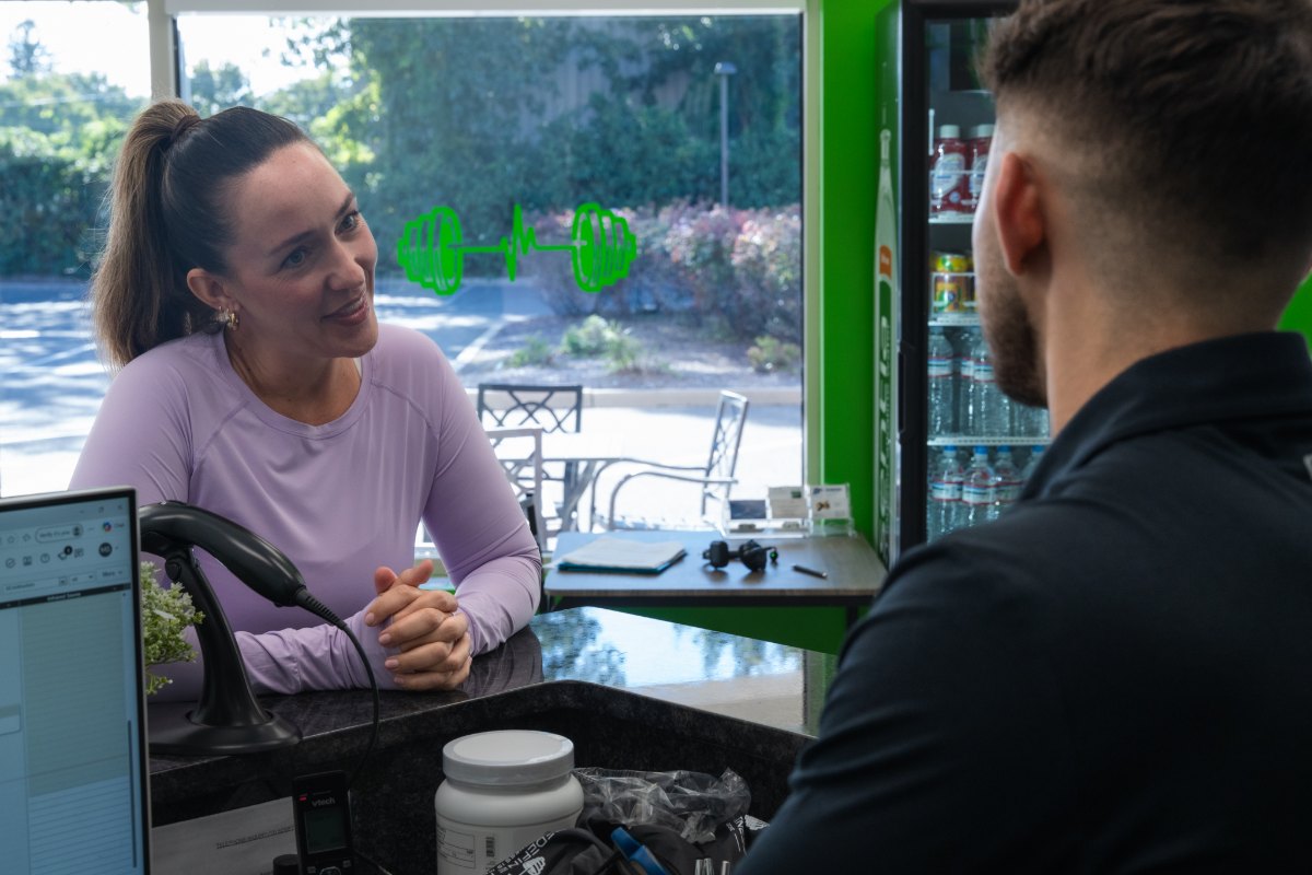 A Redefine Fitness client at the front desk during her call