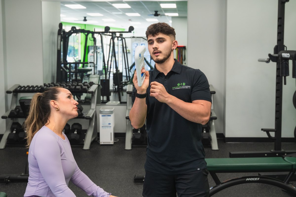 Fitness Specialist explaining the grip strength test during the Redefine Fitness screening