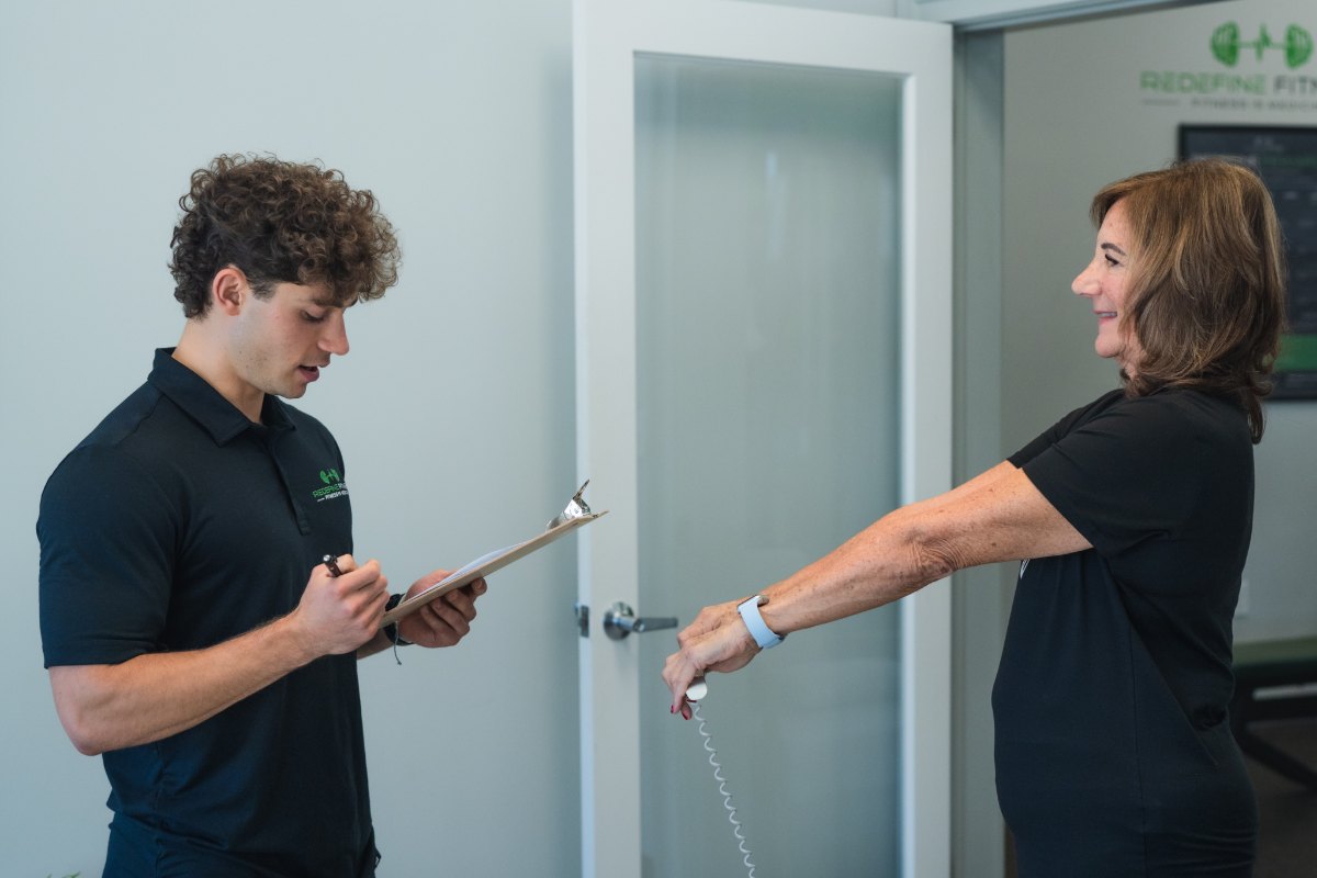 Fitness Specialist James Moore running a portable InBody scan on a client at Redefine Fitness